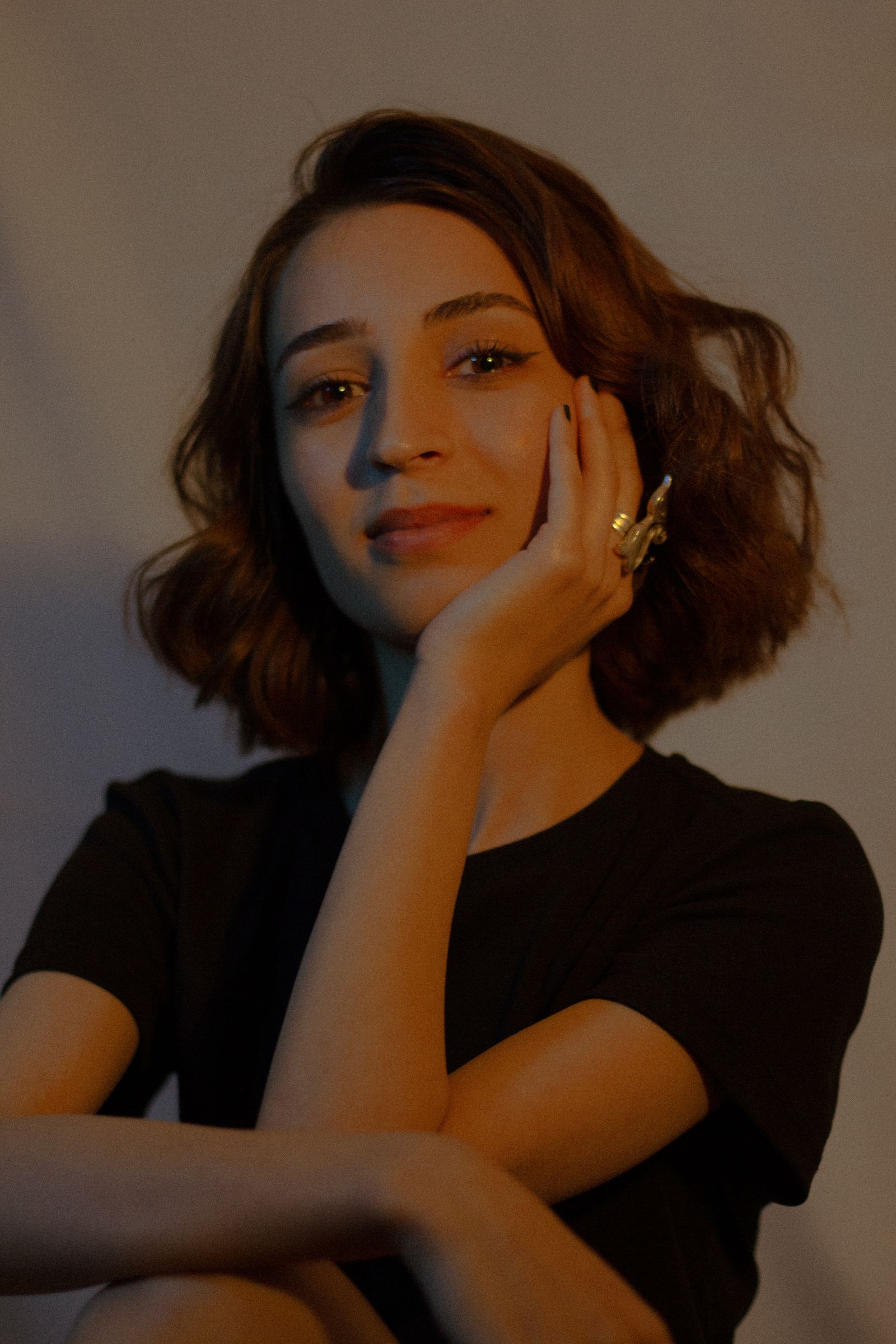 15 Elegant Italian Bob Haircut Ideas for a Sophisticated Look Portrait of a woman with wavy bob-length hair wearing a t-shirt indoors