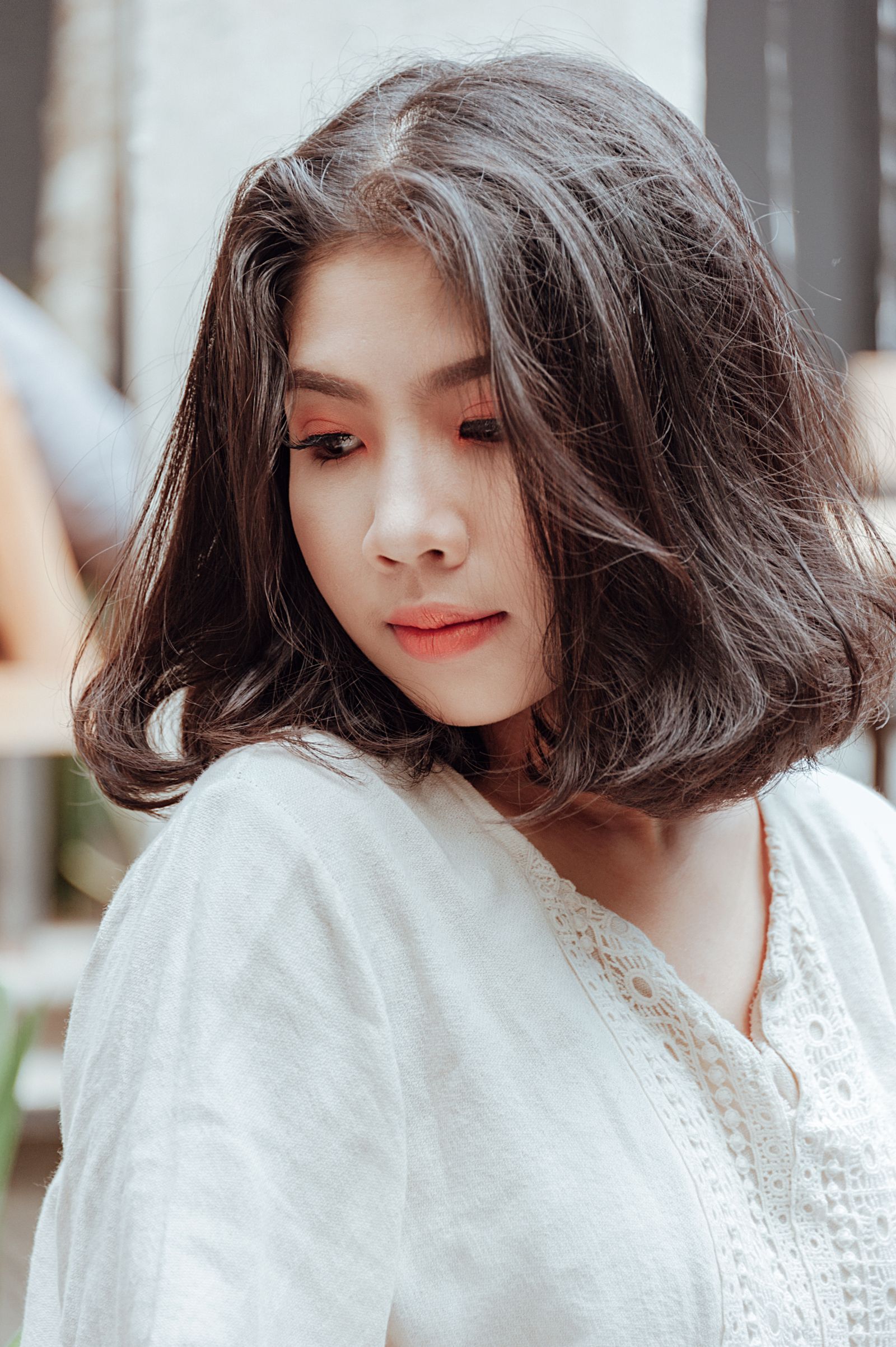 15 Elegant Italian Bob Haircut Ideas for a Sophisticated Look Close-up portrait of a young woman with short bob-length hair looking down