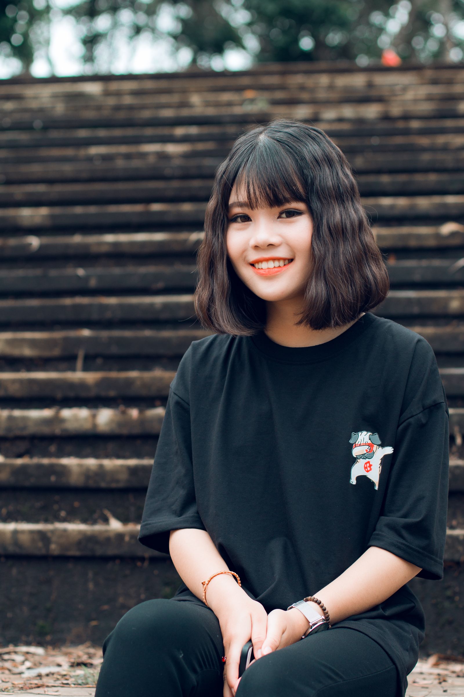 15 Elegant Italian Bob Haircut Ideas for a Sophisticated Look Cheerful young woman with short bob-length hair sitting outdoors on stairs