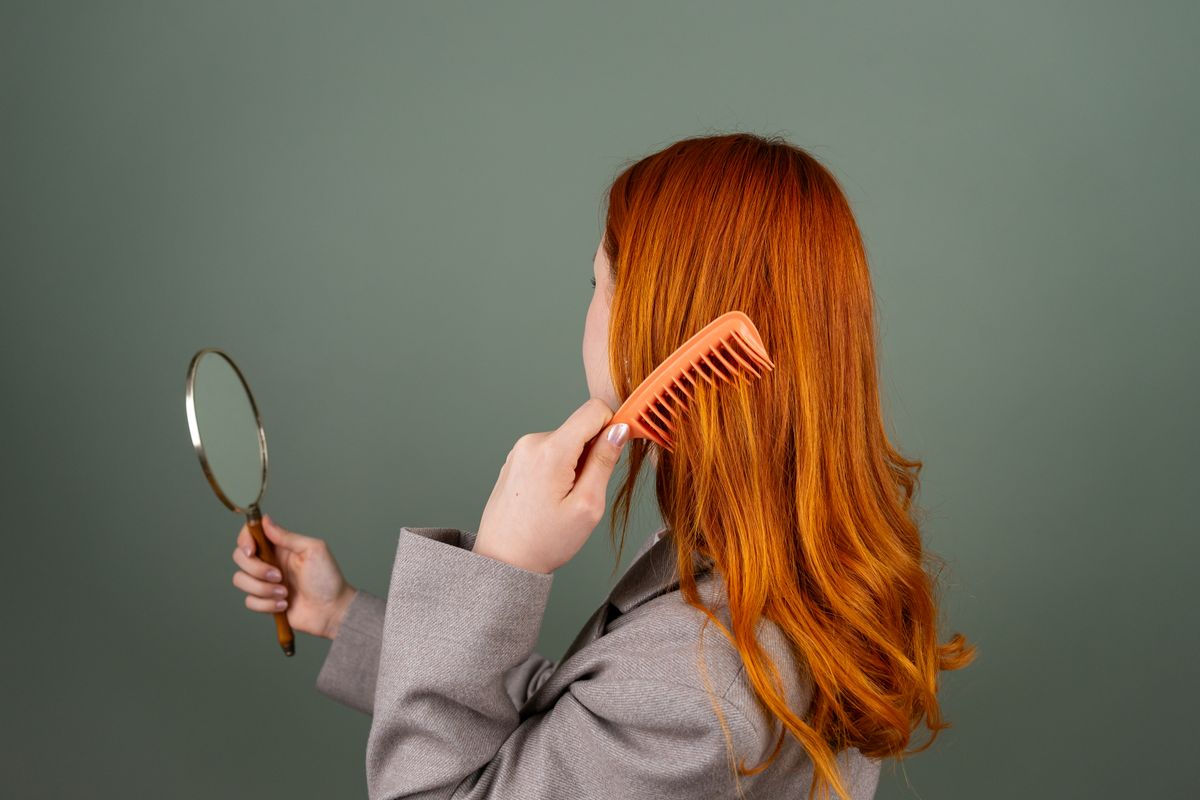 12 Essential Hair Care Tips for Healthy, Gorgeous Hair (2026 Guide) Checking hair ends before a trim — hair care tips