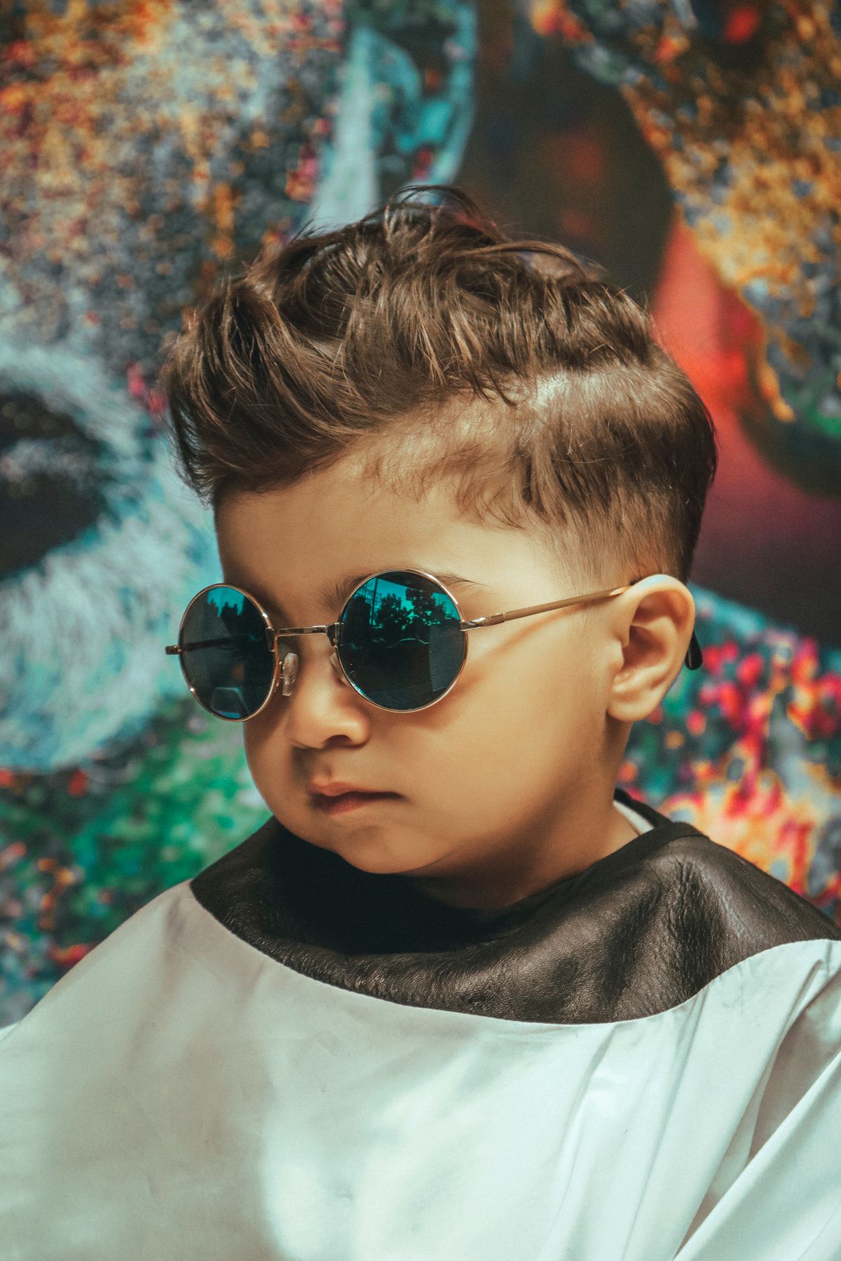 15 Cool Haircuts for Boys (2026 Guide for Every Age) Cool haircut for boys — little boy with stylish quiff at barbershop