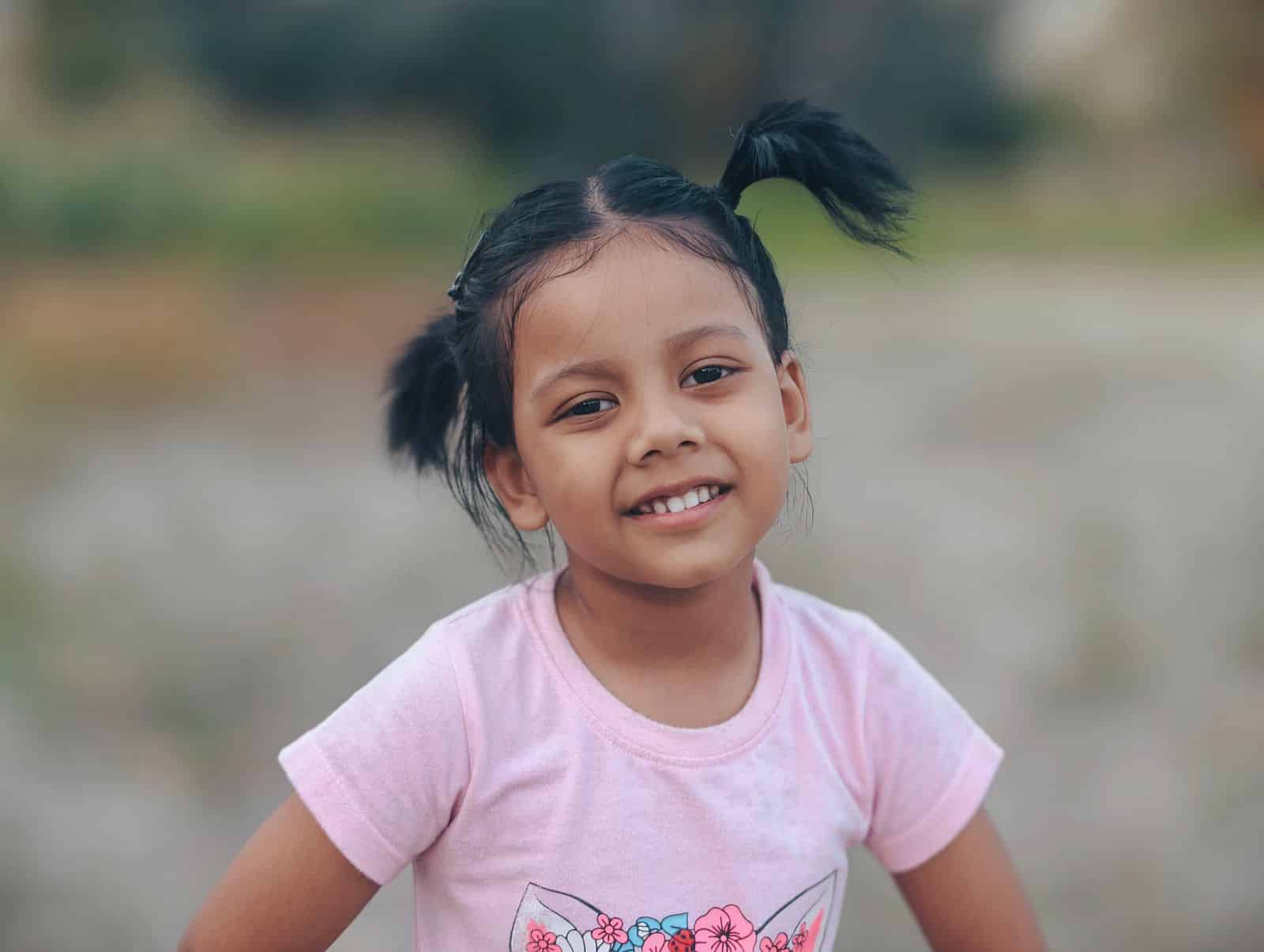 20 Adorable Halloween Hairstyles for Kids to Try Pumpkin puff pigtails — cute halloween hairstyle for kids