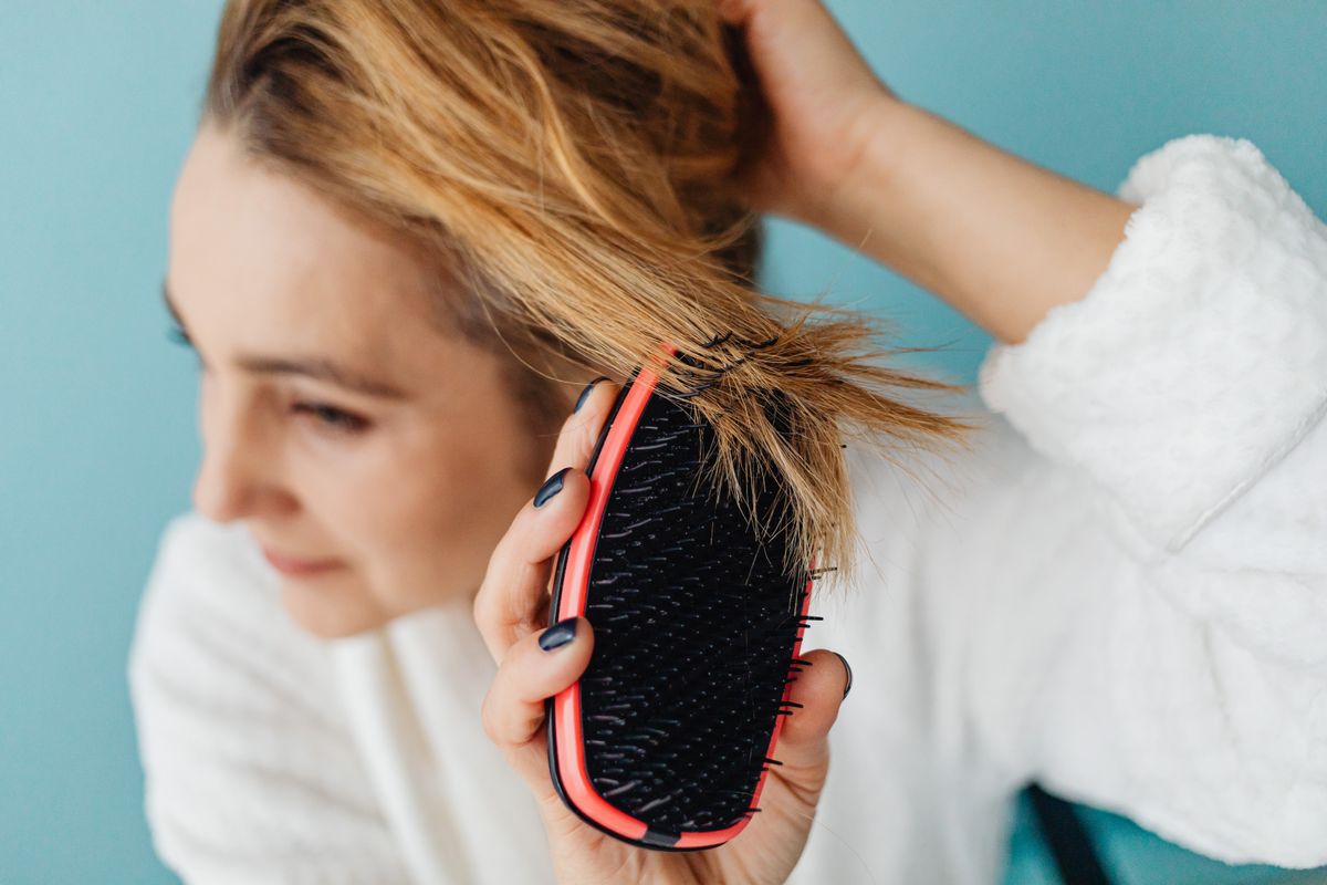12 Essential Hair Care Tips for Healthy, Gorgeous Hair (2026 Guide) Gentle hair brushing — healthy hair care tips
