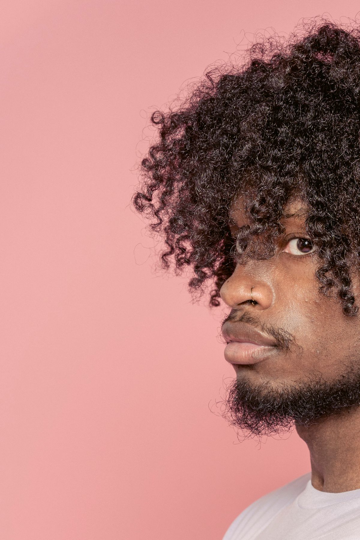 15 Sharp Haircuts for Black Men (2026 Guide) Curly top haircut for black men with beard