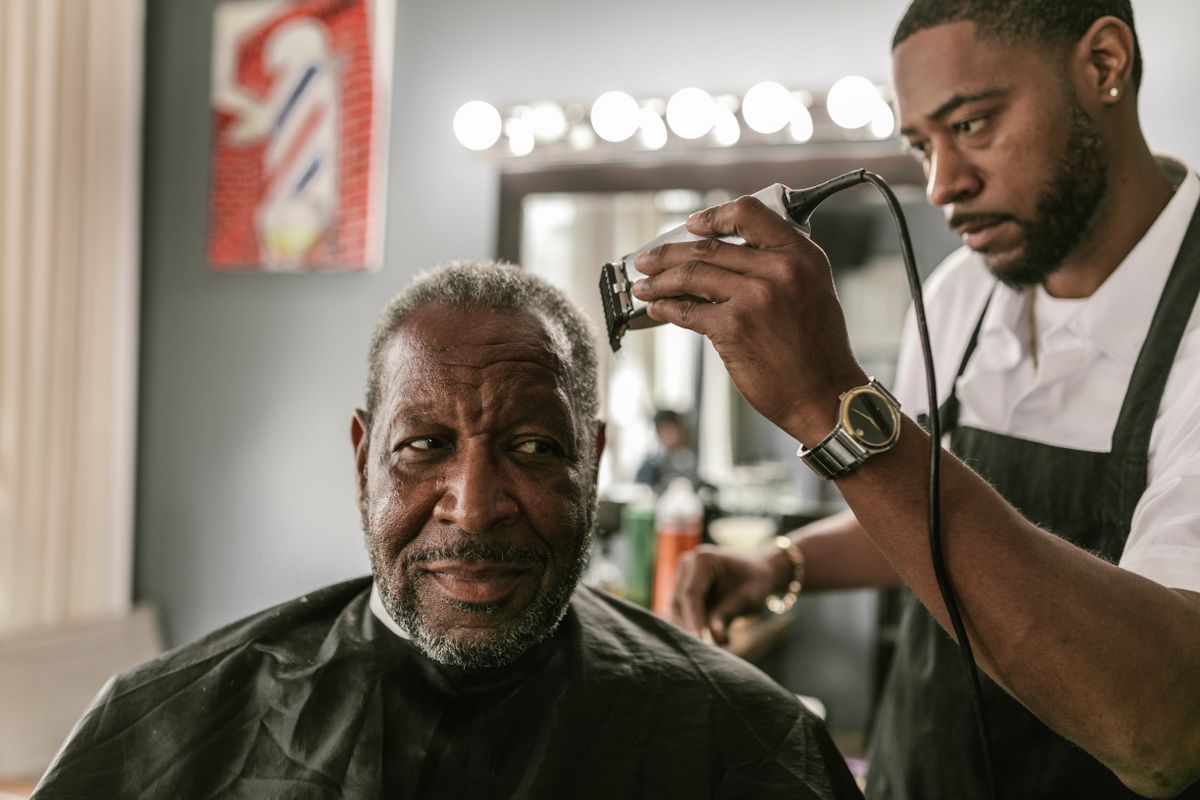 15 Sharp Haircuts for Black Men (2026 Guide) Barber cutting black men's hair — find the right barber