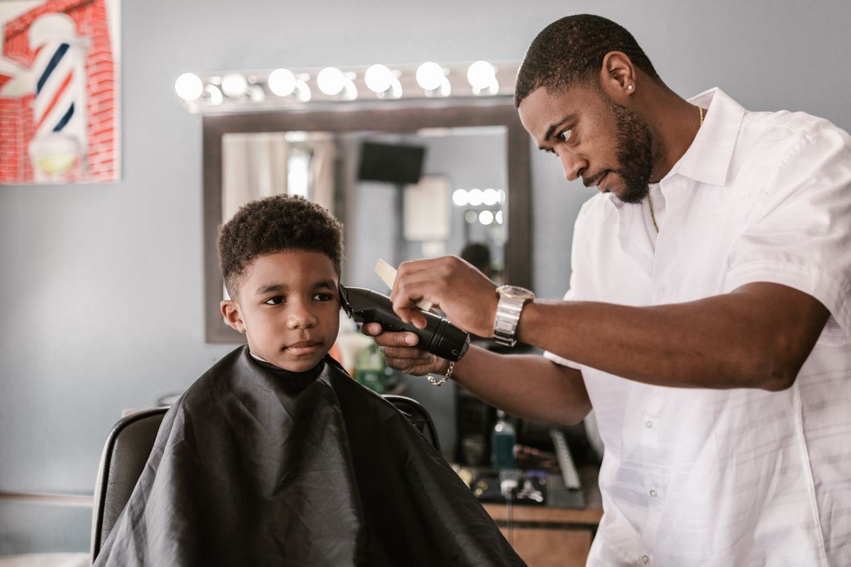 15 Cool Haircuts for Boys (2026 Guide for Every Age) Barber giving a boy a haircut — haircuts for boys